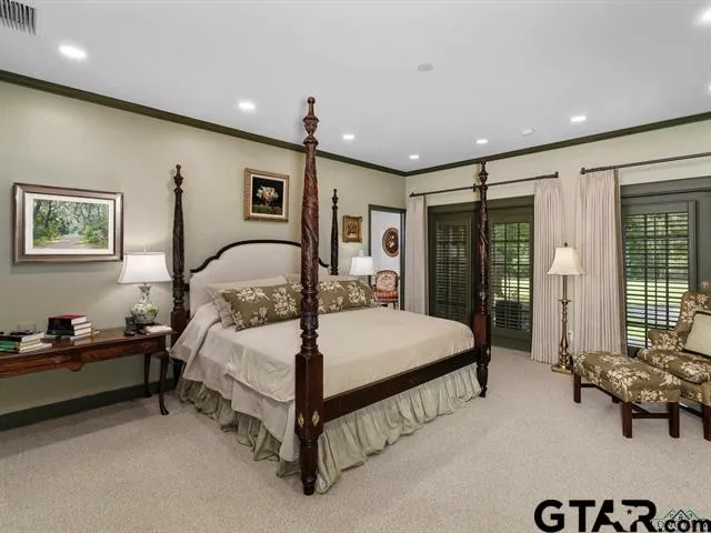 a bedroom with a bed and a large mirror