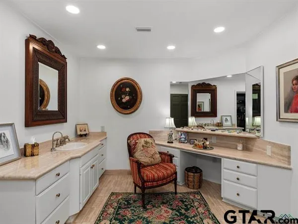 a spacious bathroom with a double vanity sink and a mirror
