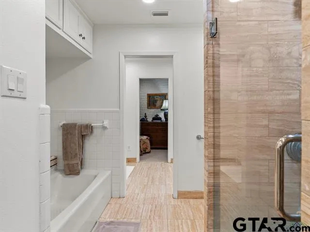 a bathroom with a bathtub and a shower