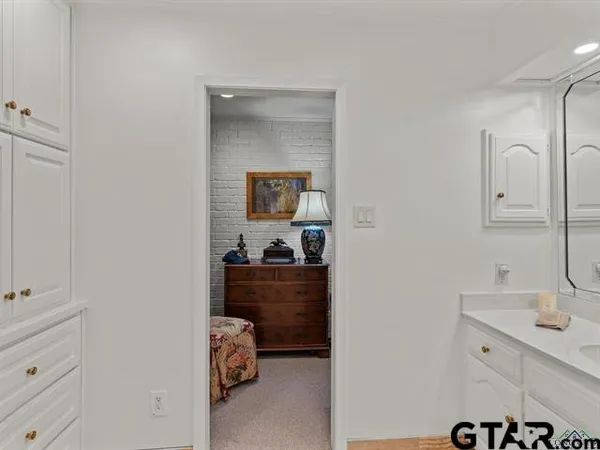 a room with a sink and mirror