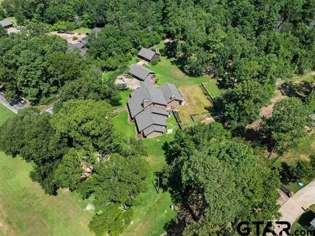 an aerial view of a house with a yard