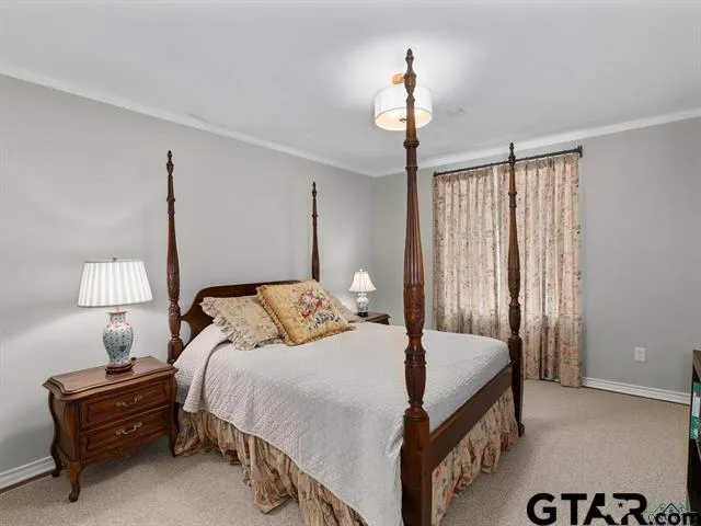 a bedroom with a bed and a lamp