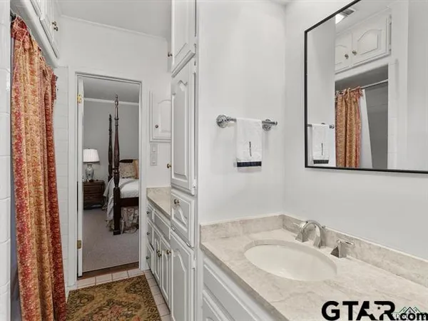 a en suite bathroom with a sink a mirror and a shower