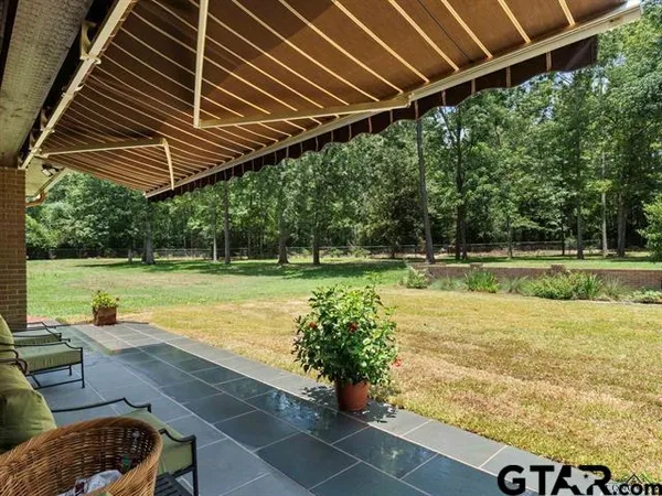 a view of a backyard with swimming pool