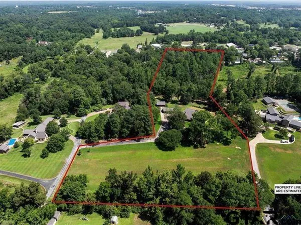 an aerial view of a house with yard