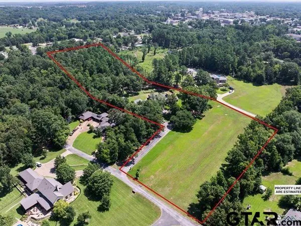 an aerial view of residential houses with outdoor space and swimming pool
