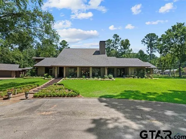 a aerial view of a house next to a yard