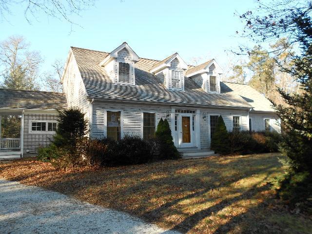 255 Little River Road Cotuit, MA 02635 - Photo 1 of 10 a front view of a house with a garden