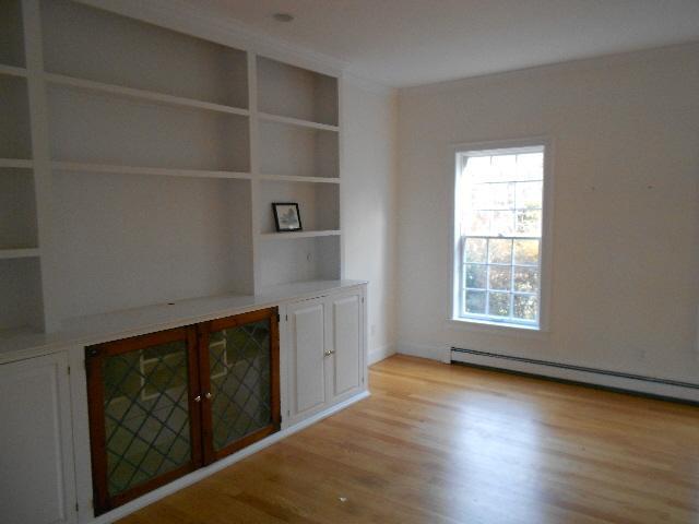255 Little River Road Cotuit, MA 02635 - Photo 4 of 10 an empty room with wooden floor and windows
