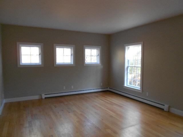 255 Little River Road Cotuit, MA 02635 - Photo 5 of 10 an empty room with wooden floor and windows