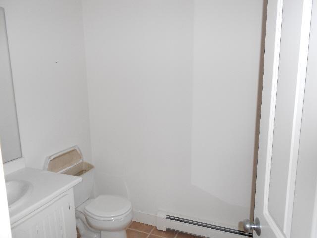 255 Little River Road Cotuit, MA 02635 - Photo 7 of 10 a white toilet sitting next to a white sink and vanity