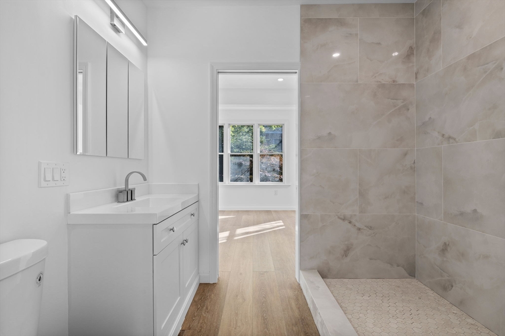 172 Lexington Avenue, Unit 1 Cambridge, MA 02138 - Photo 15 of 19 a bathroom with a sink a toilet and shower