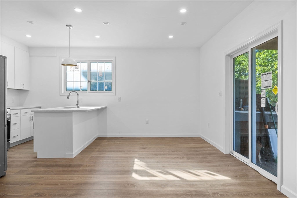 172 Lexington Avenue, Unit 1 Cambridge, MA 02138 - Photo 4 of 19 a view of a kitchen with wooden floor and a sink