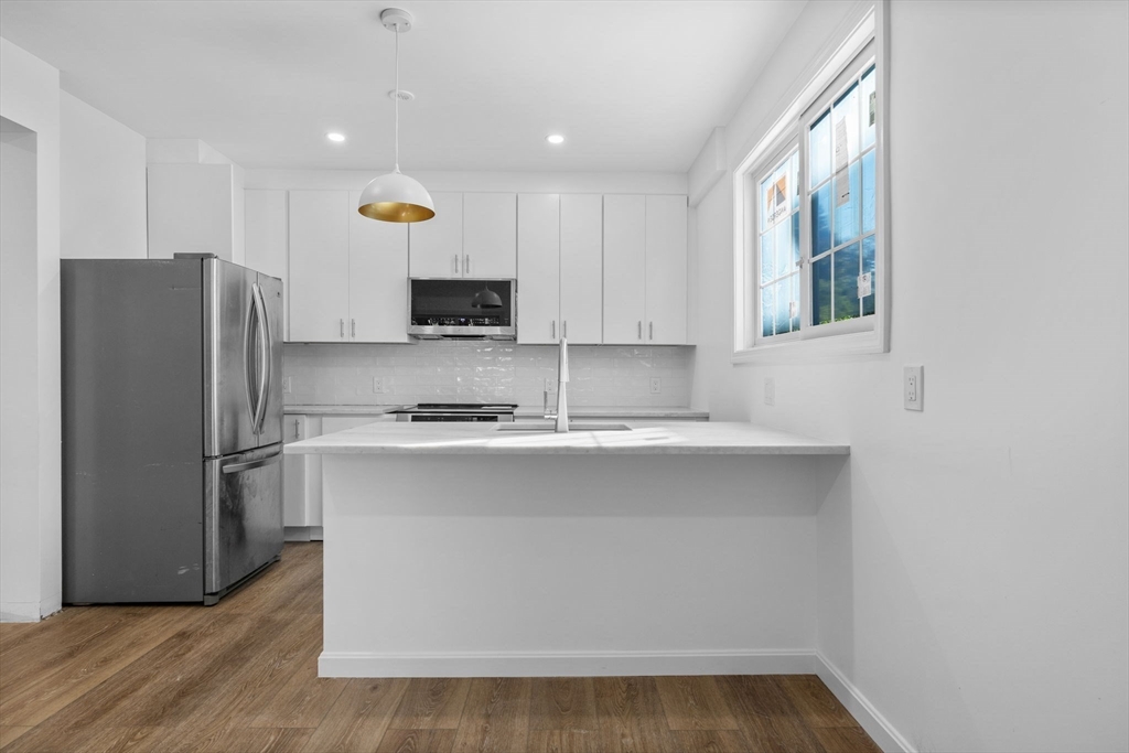 172 Lexington Avenue, Unit 1 Cambridge, MA 02138 - Photo 6 of 19 a kitchen with stainless steel appliances a refrigerator sink and microwave