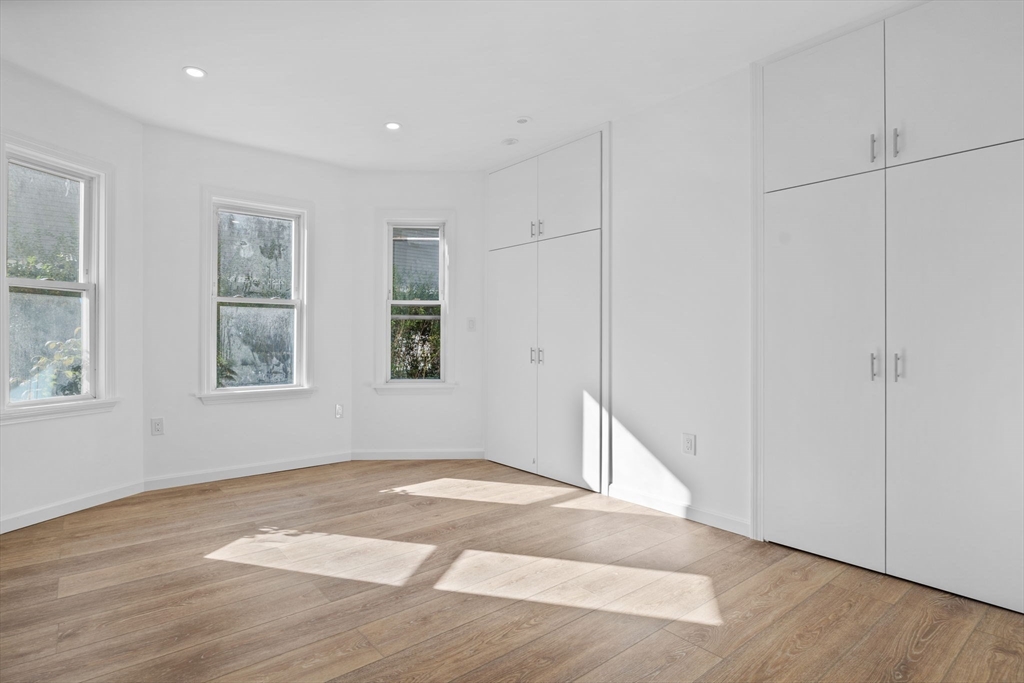 172 Lexington Avenue, Unit 1 Cambridge, MA 02138 - Photo 9 of 19 a view of empty room with wooden floor and fan