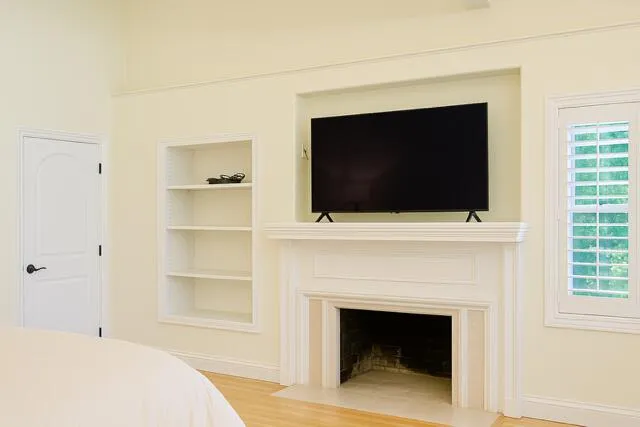 a living room with a fireplace and a flat screen tv
