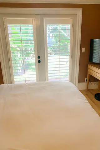 a bedroom with a bed and a chair