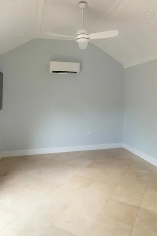 a view of a refrigerator in an empty room