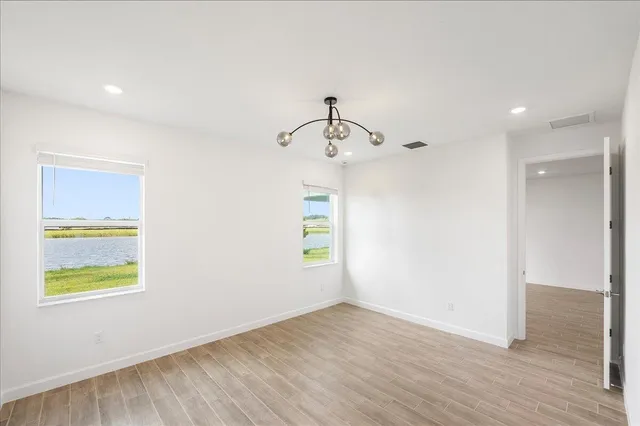 a view of empty room with a kitchen