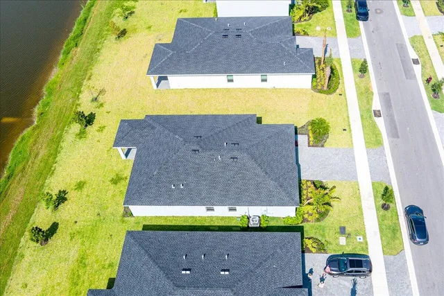 an aerial view of a house with a swimming pool yard and outdoor seating