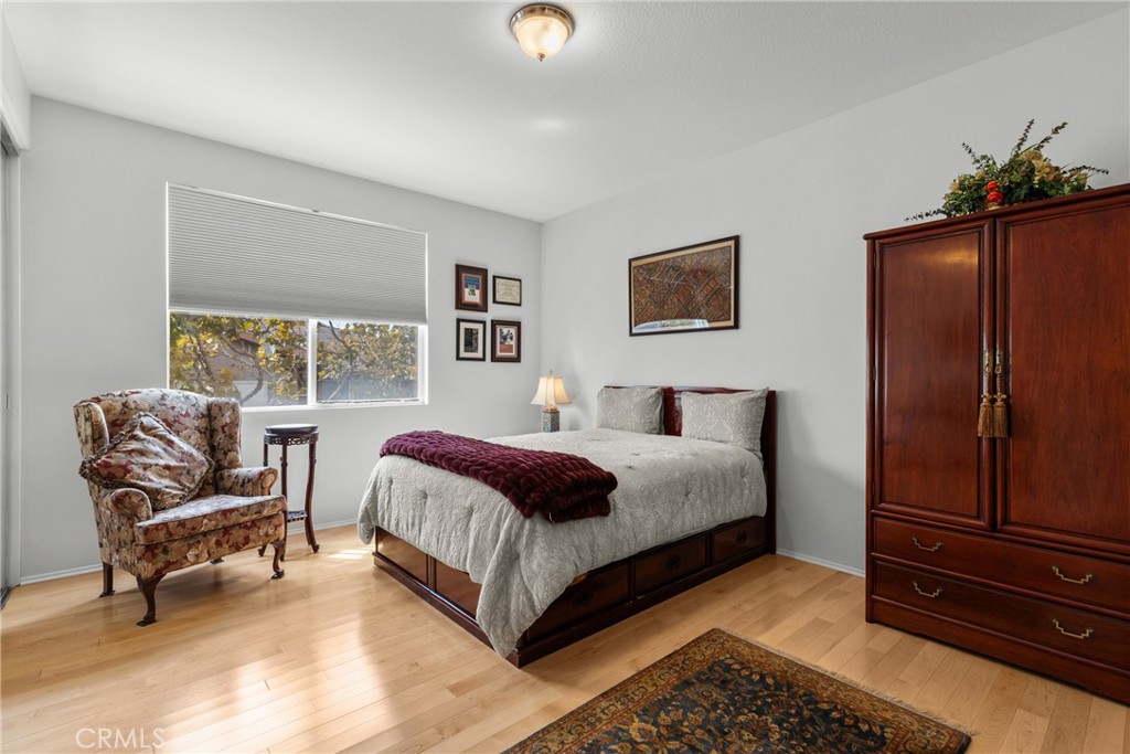 17823 Poplar Court Carson, CA 90746 - Photo 15 of 30 a spacious bedroom with a bed and chair