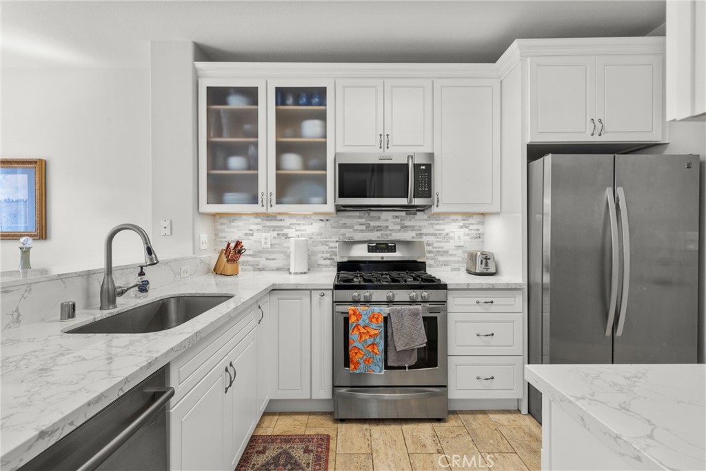17823 Poplar Court Carson, CA 90746 - Photo 6 of 30 a kitchen with stainless steel appliances granite countertop a refrigerator stove and sink