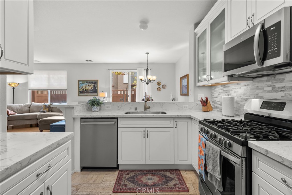 17823 Poplar Court Carson, CA 90746 - Photo 7 of 30 a kitchen with stainless steel appliances a sink dishwasher stove microwave and cabinets