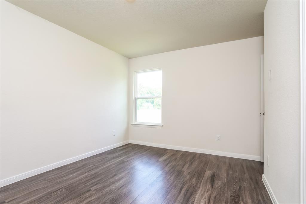 2515 Lyle Avenue Waco, TX 76708 - Photo 12 of 21 a view of an empty room with wooden floor and window