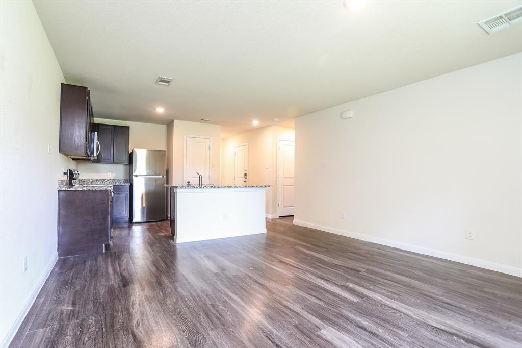 2515 Lyle Avenue Waco, TX 76708 - Photo 5 of 21 a view of kitchen with refrigerator stove microwave and cabinets