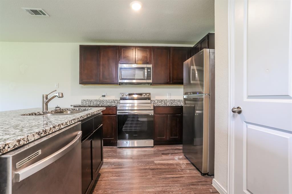 2515 Lyle Avenue Waco, TX 76708 - Photo 8 of 21 a kitchen with stainless steel appliances granite countertop a stove sink and cabinets