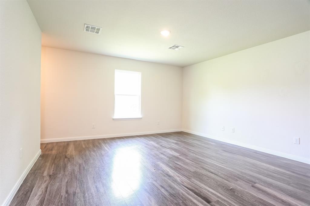 2515 Lyle Avenue Waco, TX 76708 - Photo 10 of 21 an empty room with wooden floor and windows
