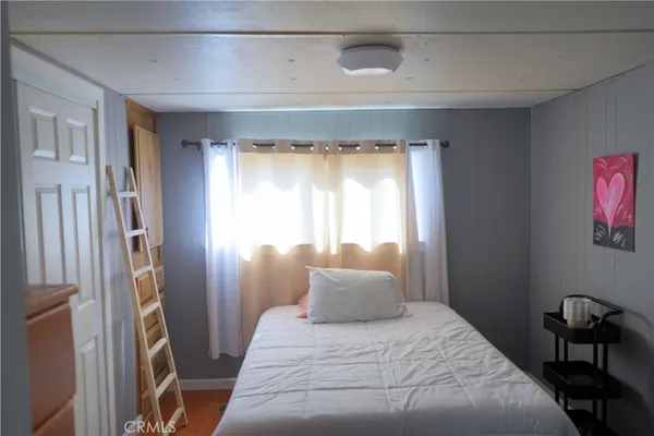 a bedroom with a bed and a table