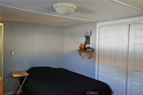 a bedroom with a bed and cabinets