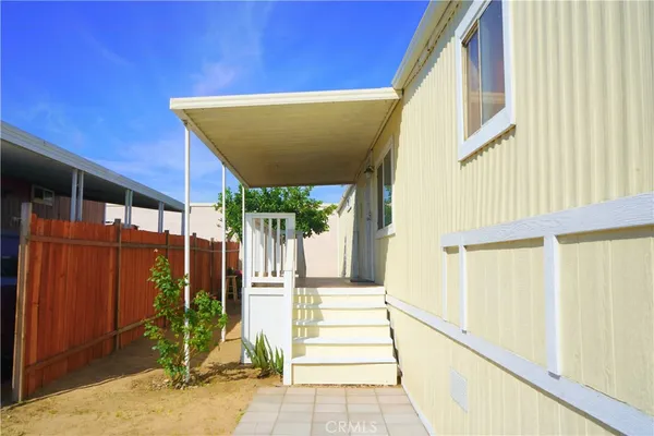 a view of a house with a door and wooden walls