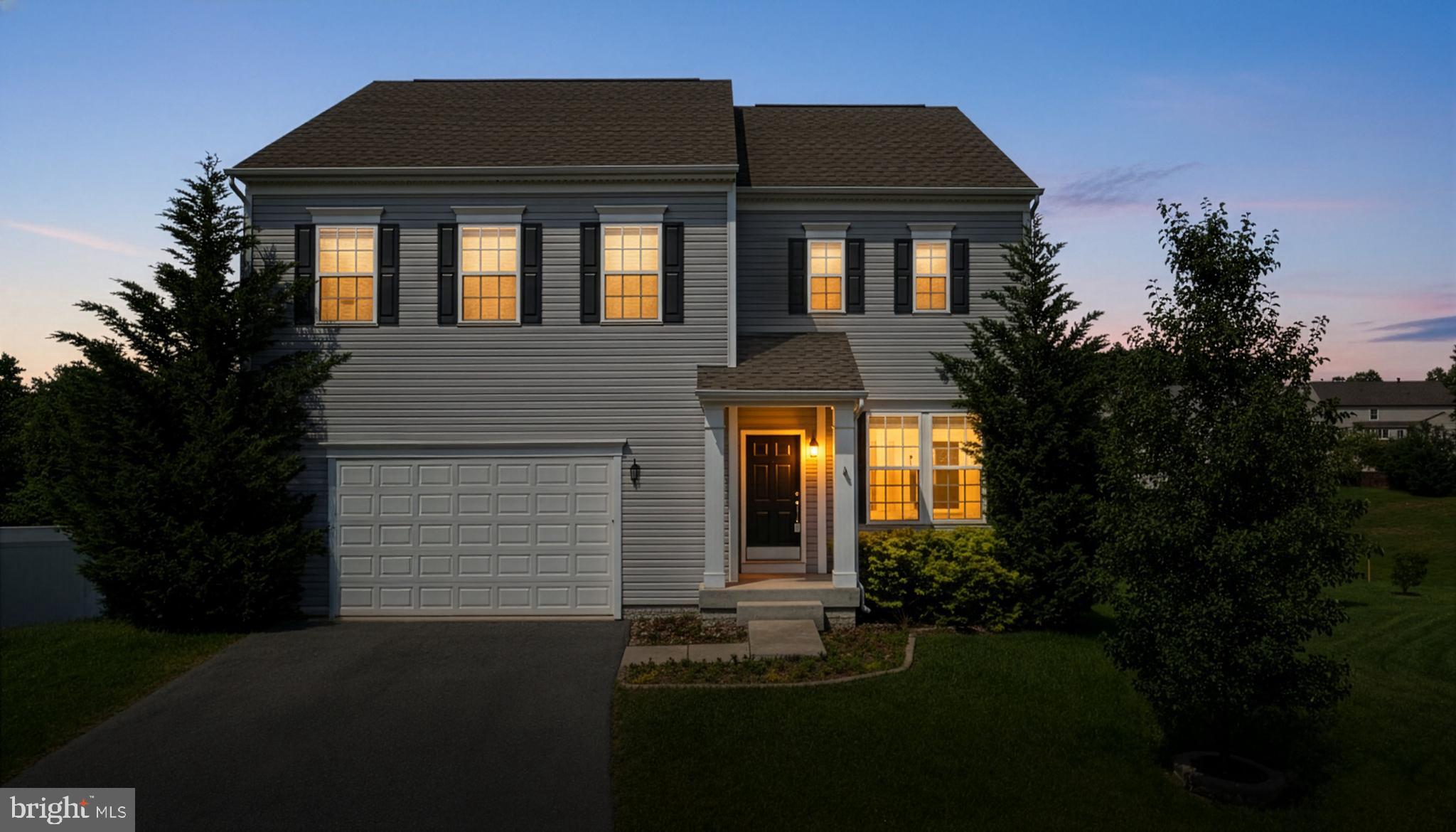 a front view of house with a garden