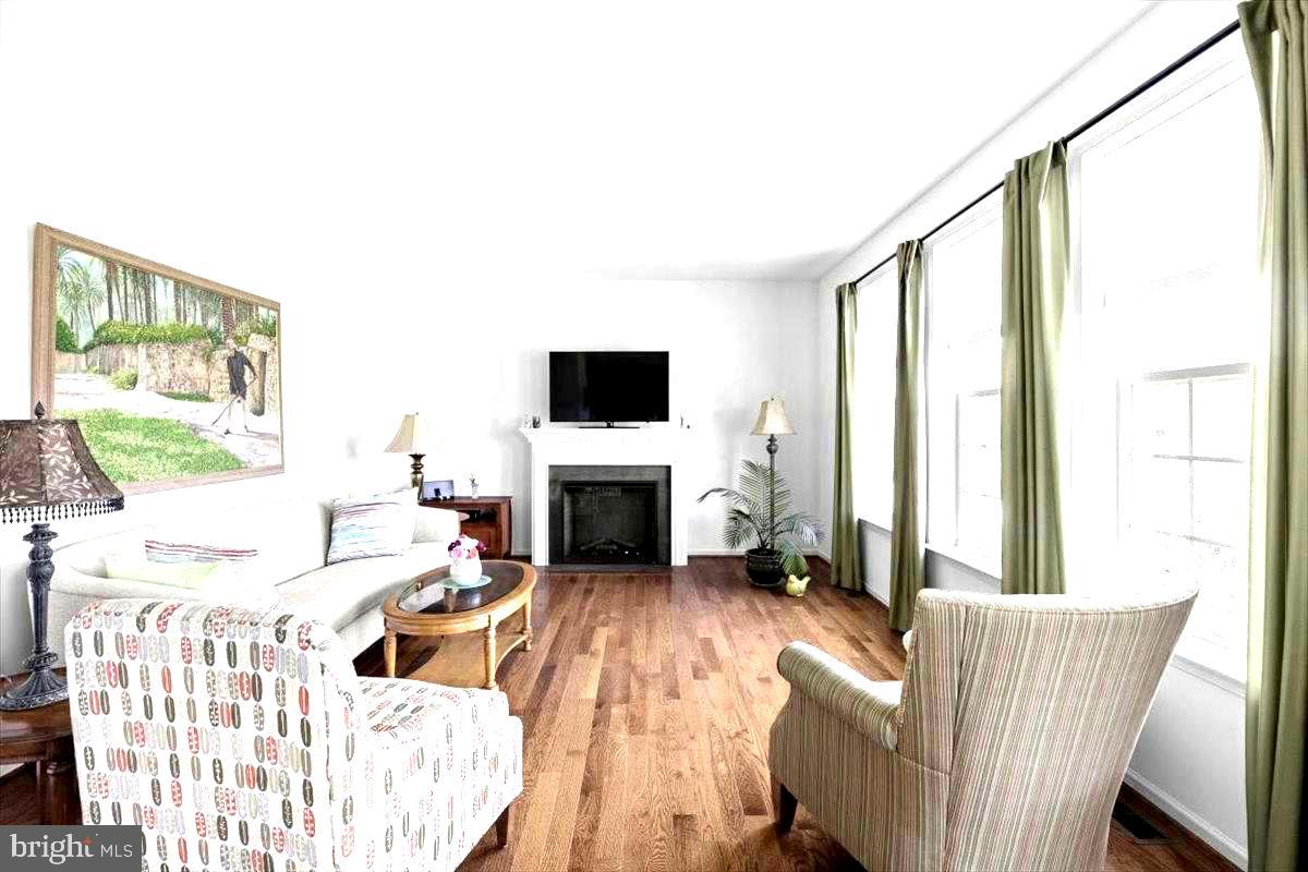 100 Taylor Court Stephenson, VA 22656 - Photo 2 of 36 a living room with furniture a fireplace and a flat screen tv