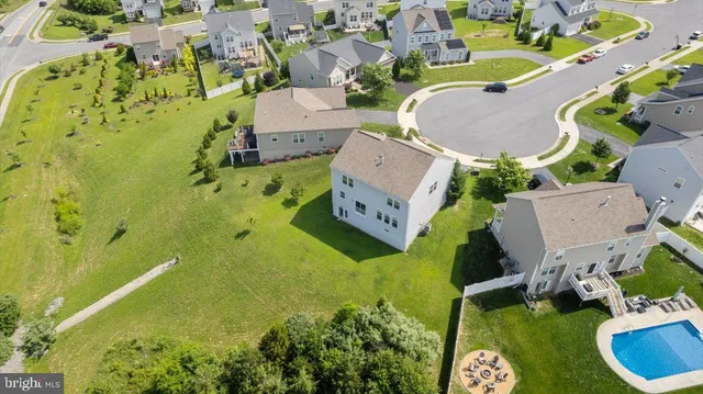 an aerial view of residential house with outdoor space and swimming pool