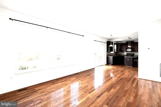 a view of a kitchen with wooden floor