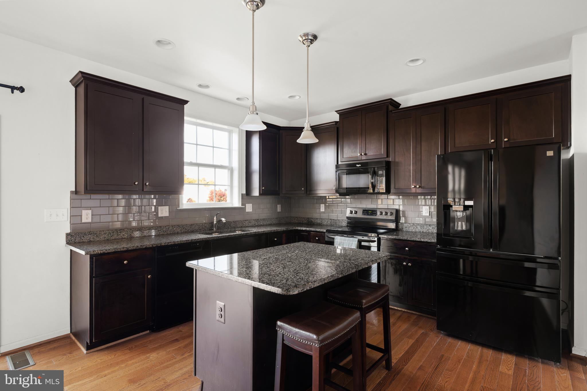 100 Taylor Court Stephenson, VA 22656 - Photo 7 of 36 a kitchen with granite countertop a sink appliances and cabinets