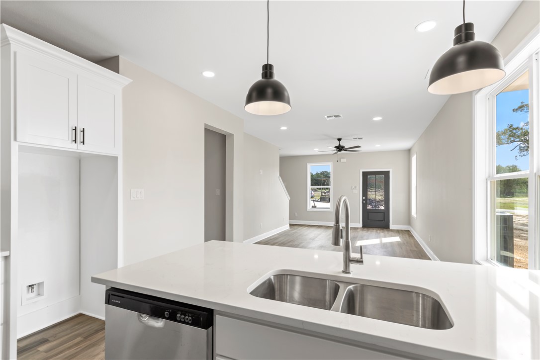 11001-11005 Breedlove Road College Station, TX 77845 - Photo 10 of 40 Kitchen featuring white cabinets, dark wood-style flooring, recessed lighting, dishwasher, and hanging light fixtures