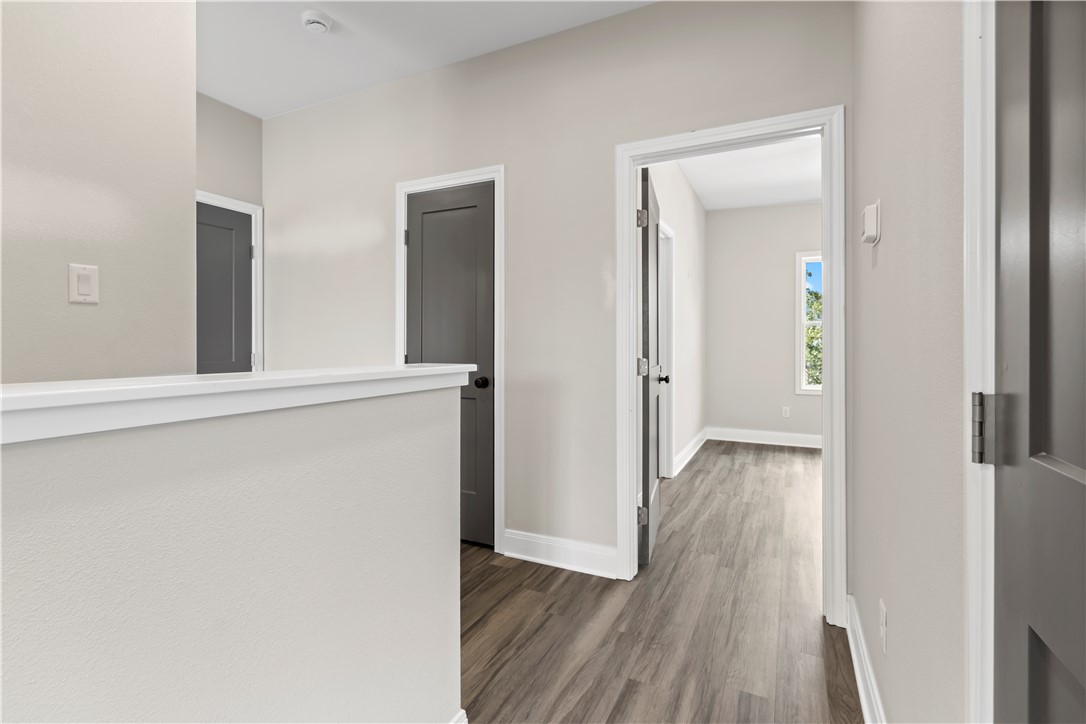 11001-11005 Breedlove Road College Station, TX 77845 - Photo 17 of 40 Corridor with dark wood-style floors and baseboards
