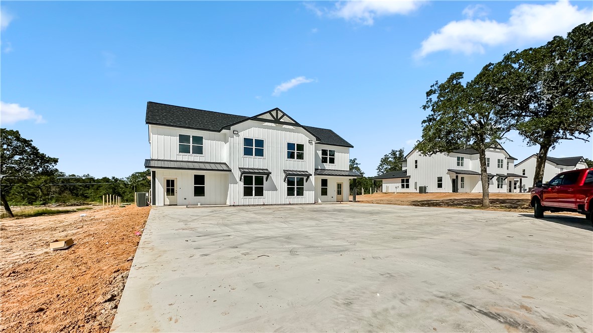 11001-11005 Breedlove Road College Station, TX 77845 - Photo 2 of 40 Modern farmhouse featuring board and batten siding, a metal roof, a standing seam roof, and a shingled roof