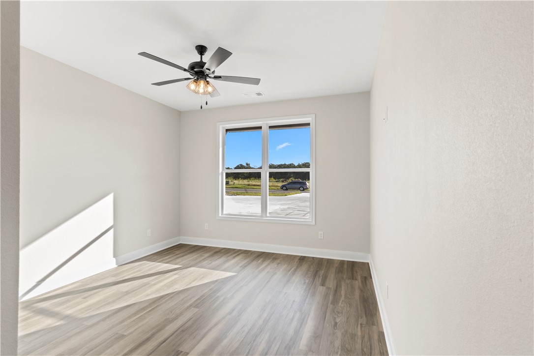 11001-11005 Breedlove Road College Station, TX 77845 - Photo 28 of 40 Spare room featuring light wood-style flooring and a ceiling fan