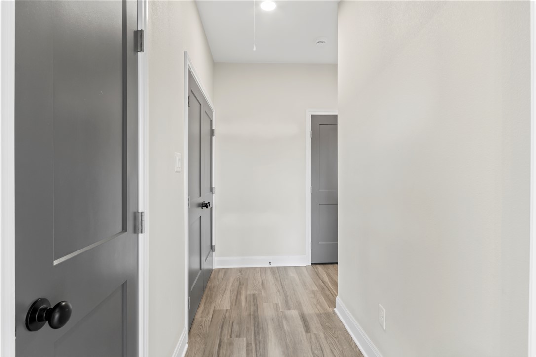 11001-11005 Breedlove Road College Station, TX 77845 - Photo 32 of 40 Hall featuring light wood-type flooring, recessed lighting, and attic access