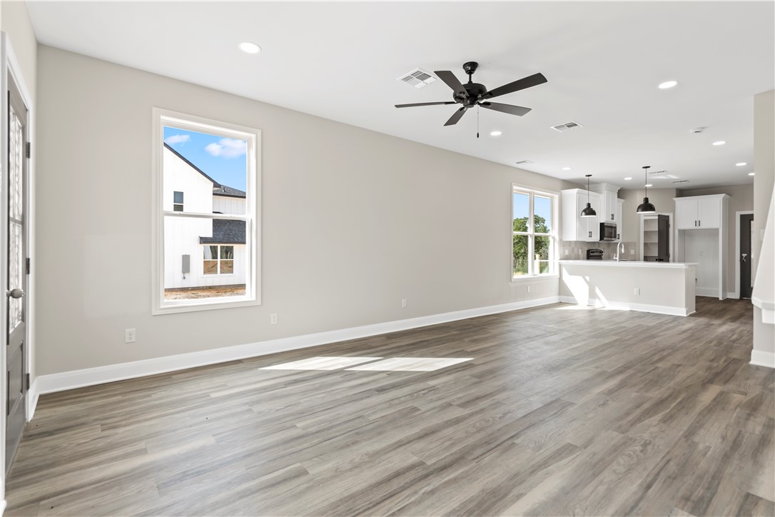11001-11005 Breedlove Road College Station, TX 77845 - Photo 6 of 40 Unfurnished living room with light wood-style floors, recessed lighting, and a ceiling fan