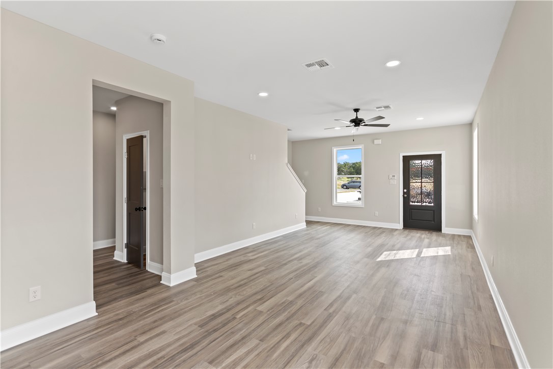 11001-11005 Breedlove Road College Station, TX 77845 - Photo 9 of 40 Unfurnished living room with recessed lighting, light wood-style flooring, and a ceiling fan