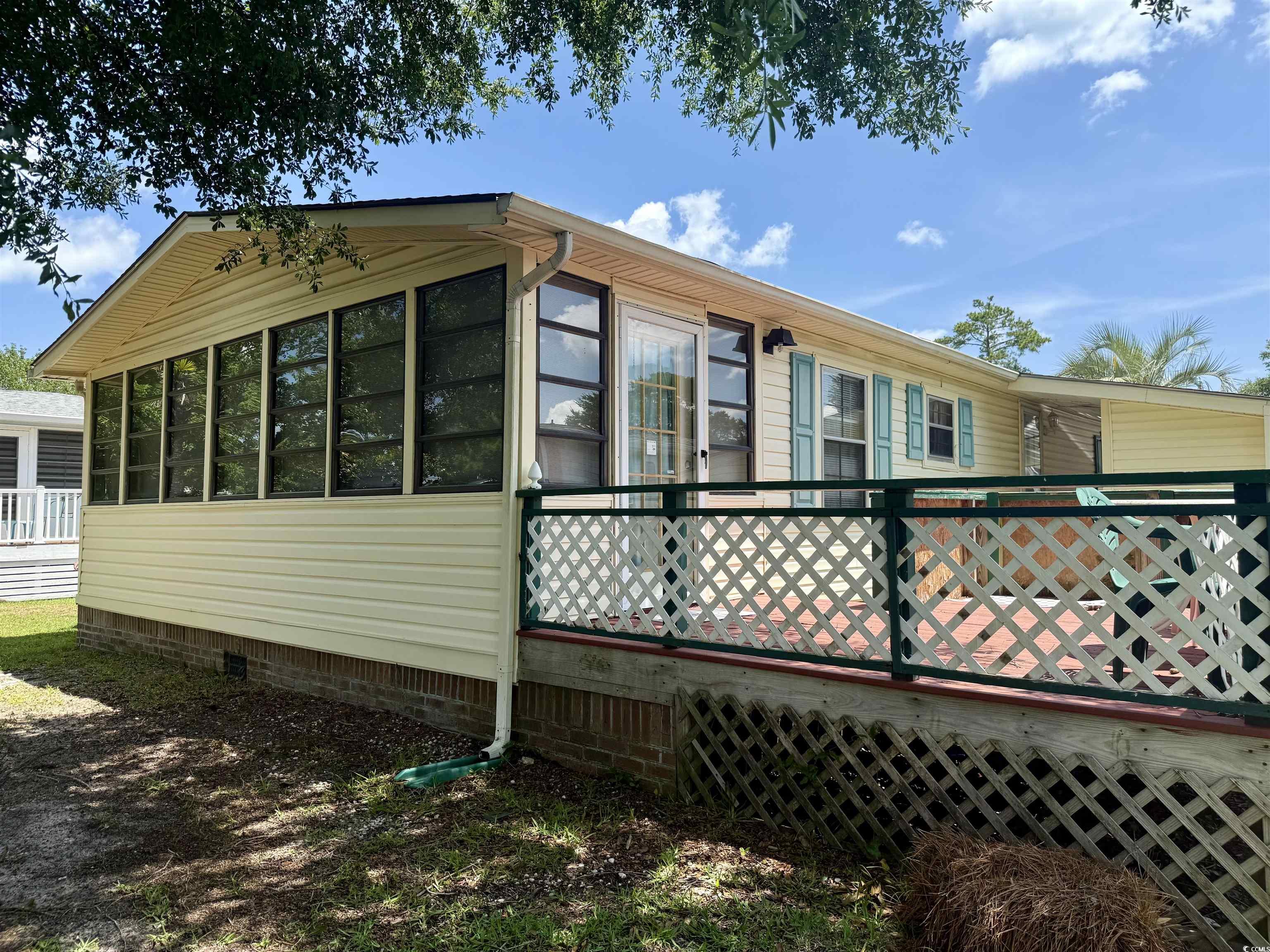 410 E Lake Surfside Beach, SC 29575 - Photo 17 of 27 View of side of home with crawl space and a sunroom