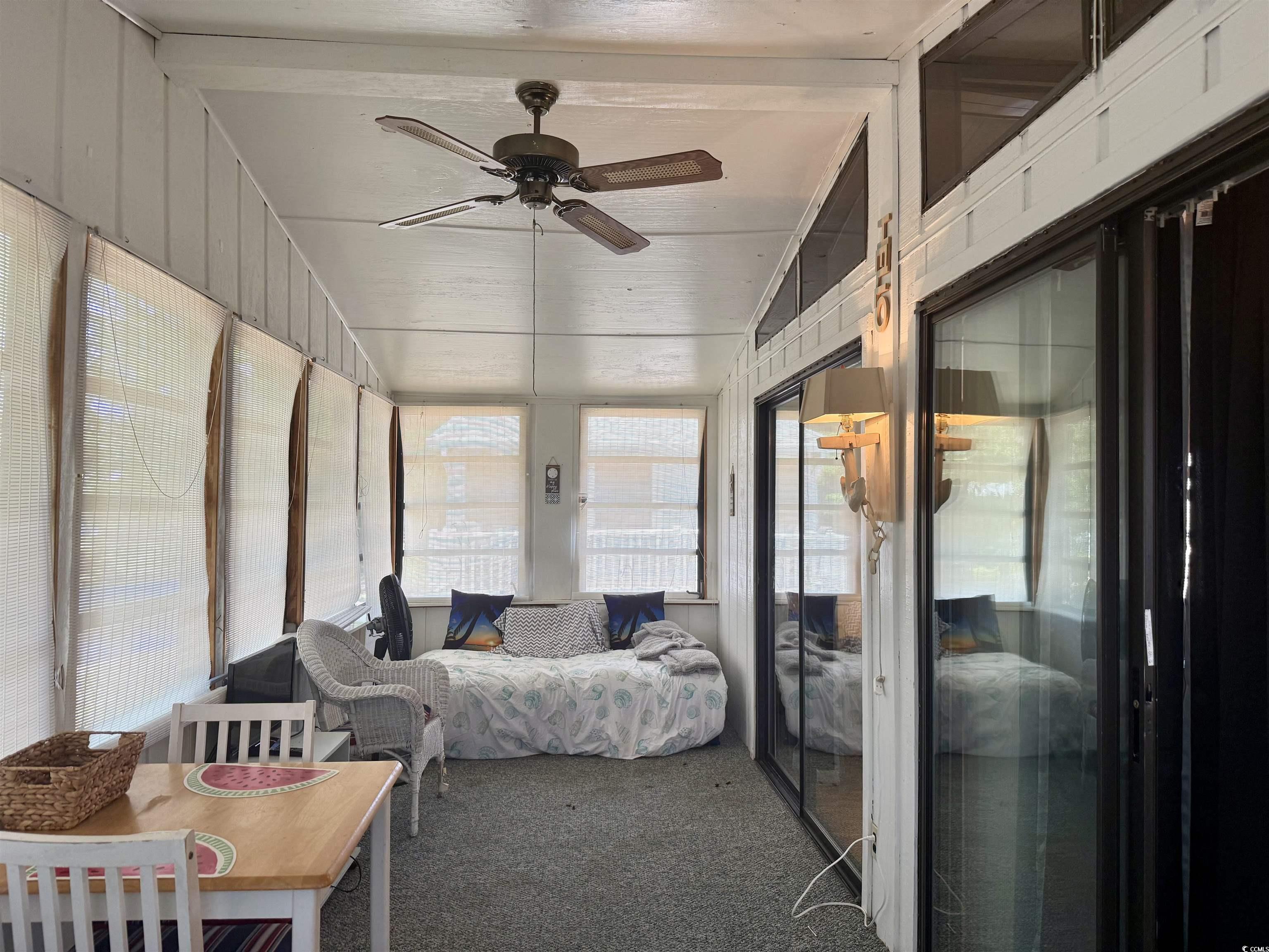 410 E Lake Surfside Beach, SC 29575 - Photo 6 of 27 Sunroom / solarium featuring carpet and ceiling fan