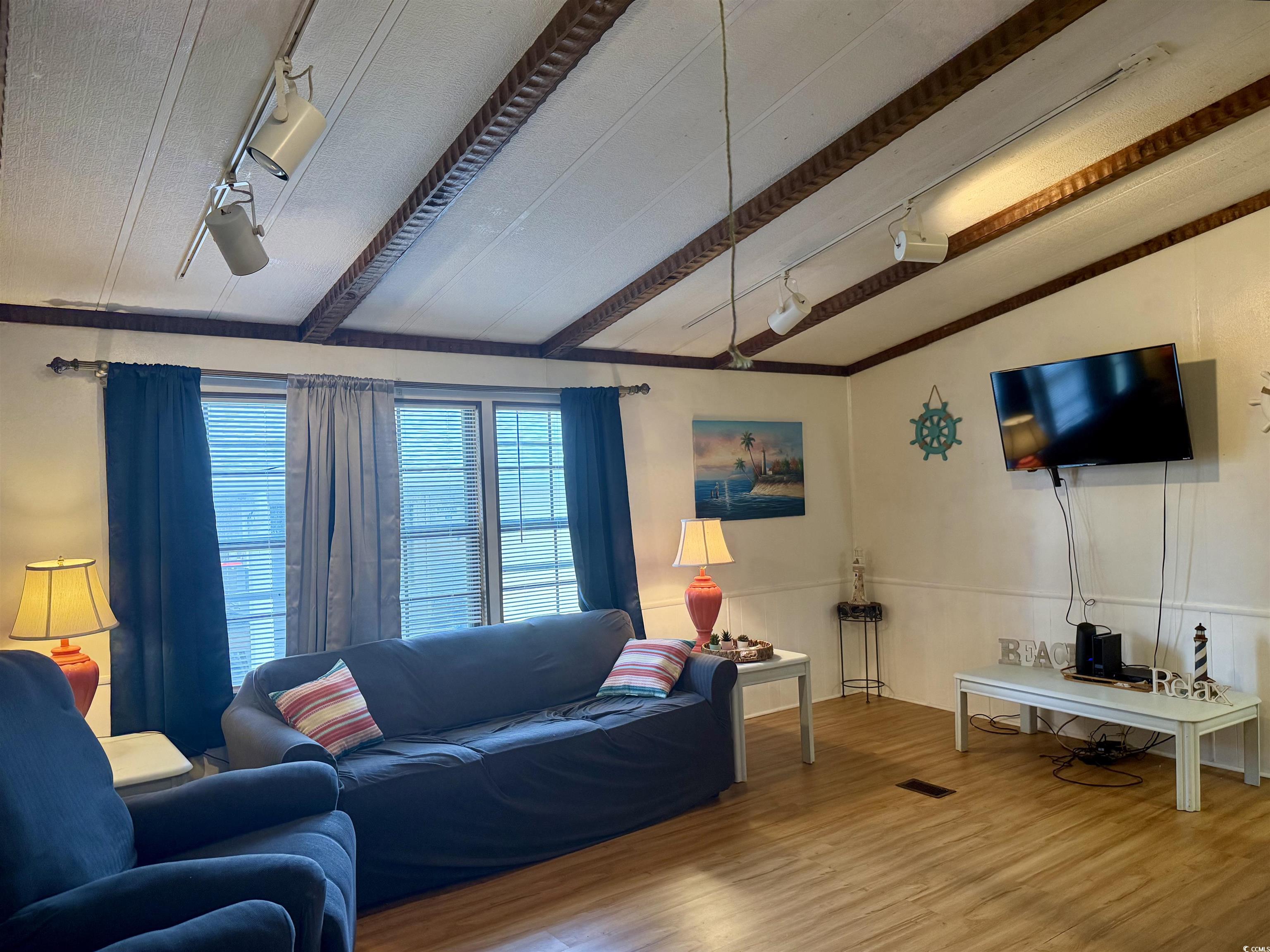410 E Lake Surfside Beach, SC 29575 - Photo 8 of 27 Living room with track lighting, wood finished floors, and lofted ceiling