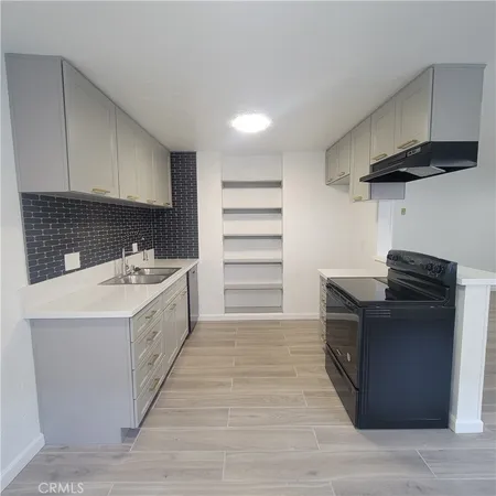 a utility room with cabinets washer and dryer